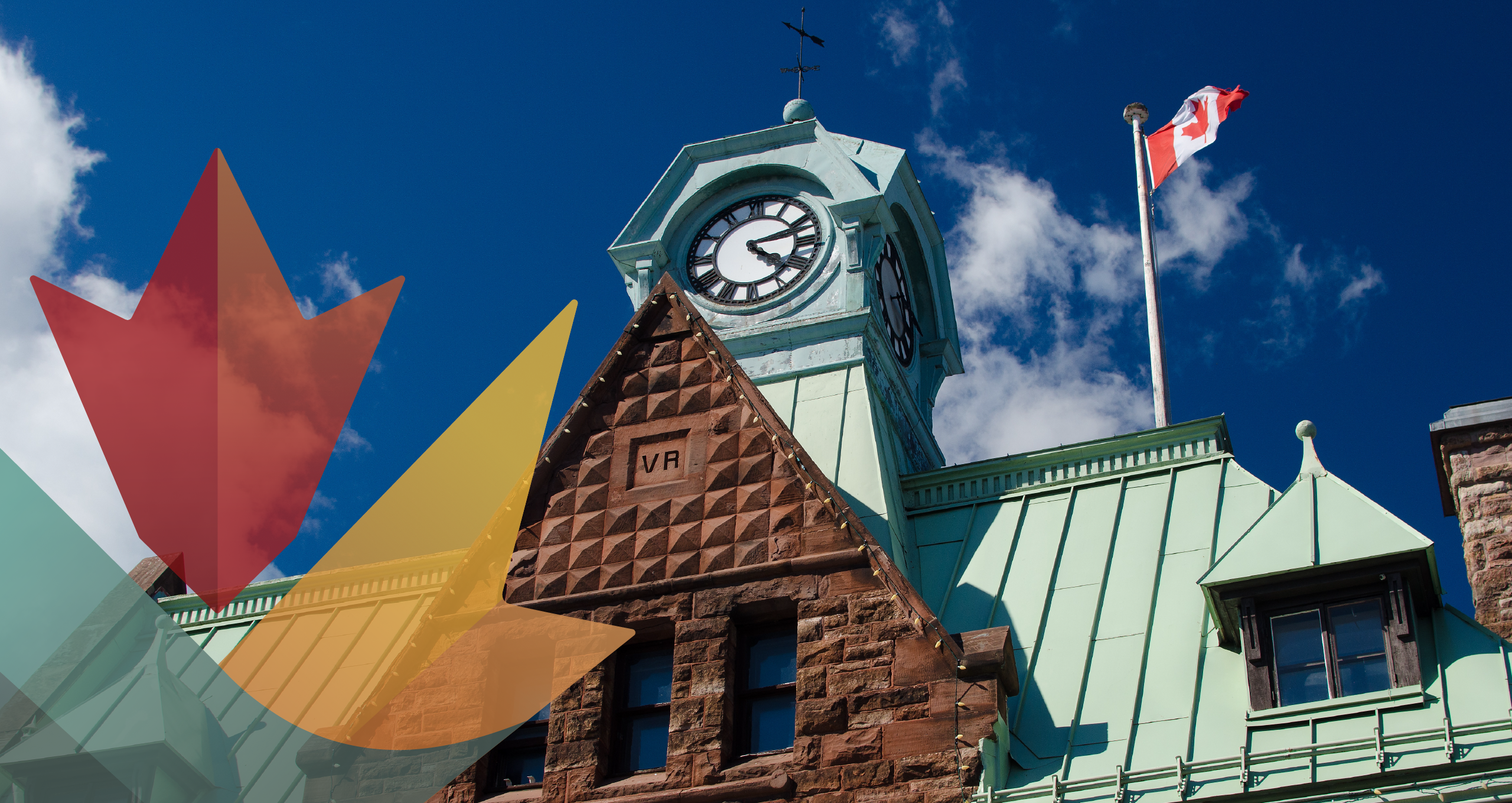 Upward angle of historic building and Canadian flag on flagpole