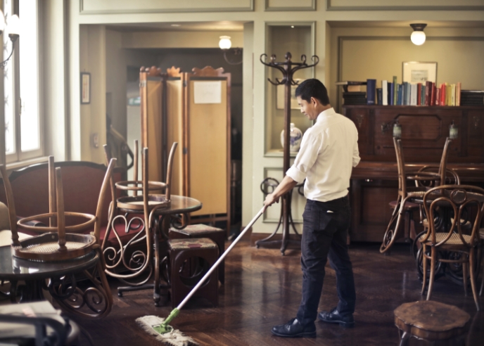 Business owner sweeping his studio space